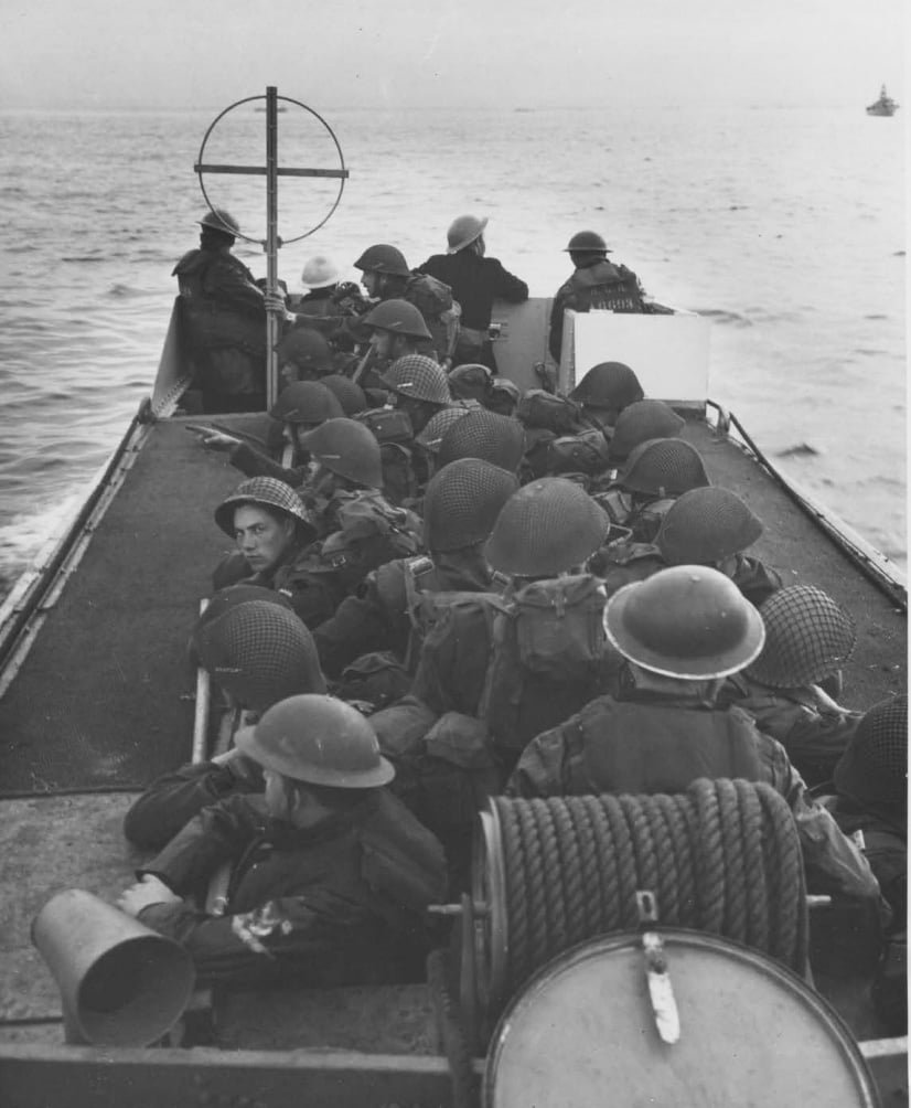 View along a small landing craft which is full of troops