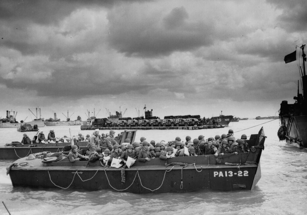 A Landing Craft, Vehicle, Personnel seen from the side, with troops on board
